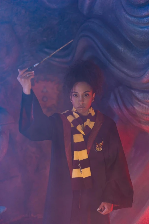 a man in a harry potter costume holding a wand, a portrait, inspired by Hermione Hammond, trending on pexels, vanessa morgan, yellow magic theme, ( ( theatrical ) ), dark