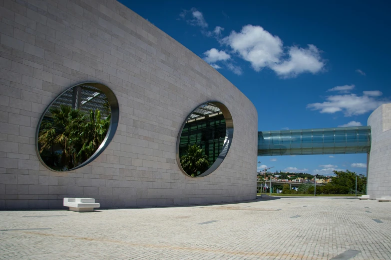 a red fire hydrant sitting in front of a building, a marble sculpture, by Joze Ciuha, academic art, circular gate in a white wall, large green glass windows, zaha hadid building, gui guimaraes