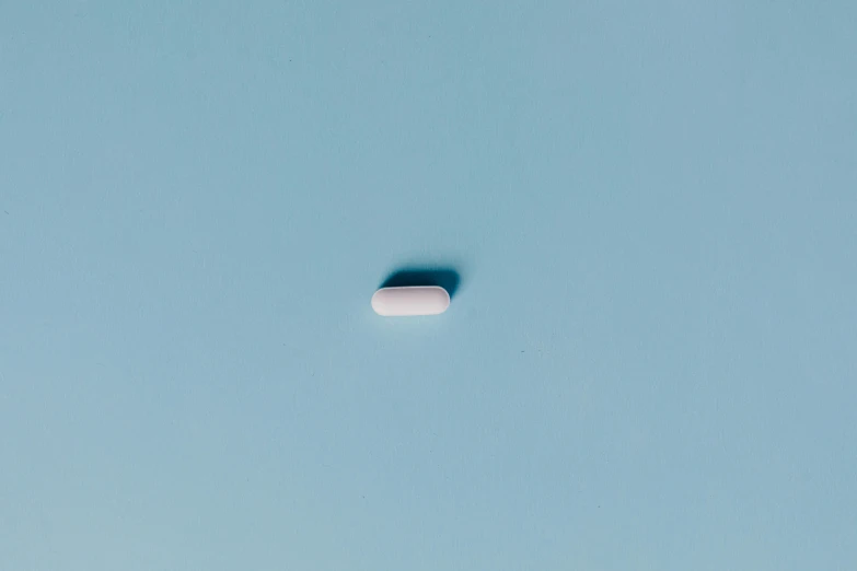 a pill sitting in the middle of a blue sky, by Elsa Bleda, antipodeans, white finish, on simple background, with a long white, ignant