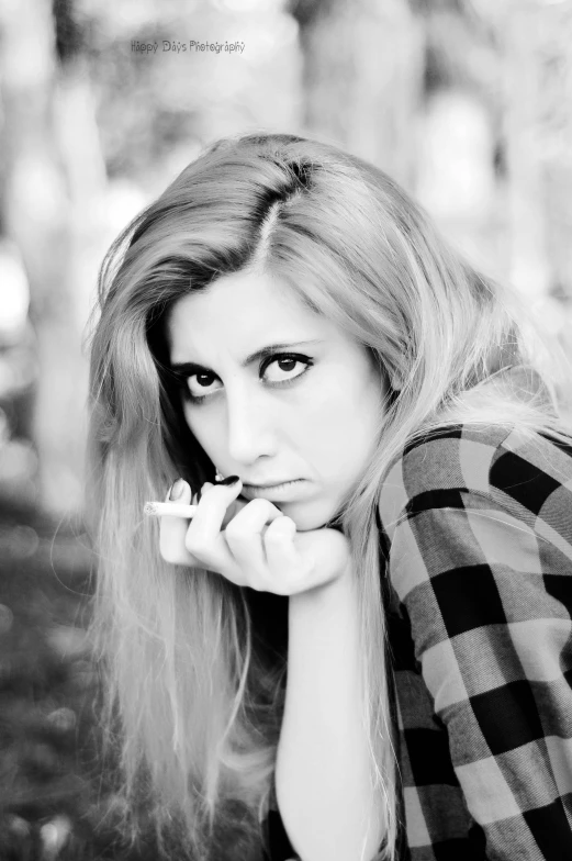 a black and white photo of a woman smoking a cigarette, inspired by Hannah Frank, flickr, realism, katherine mcnamara inspired, !!! colored photography, square nose, flannel