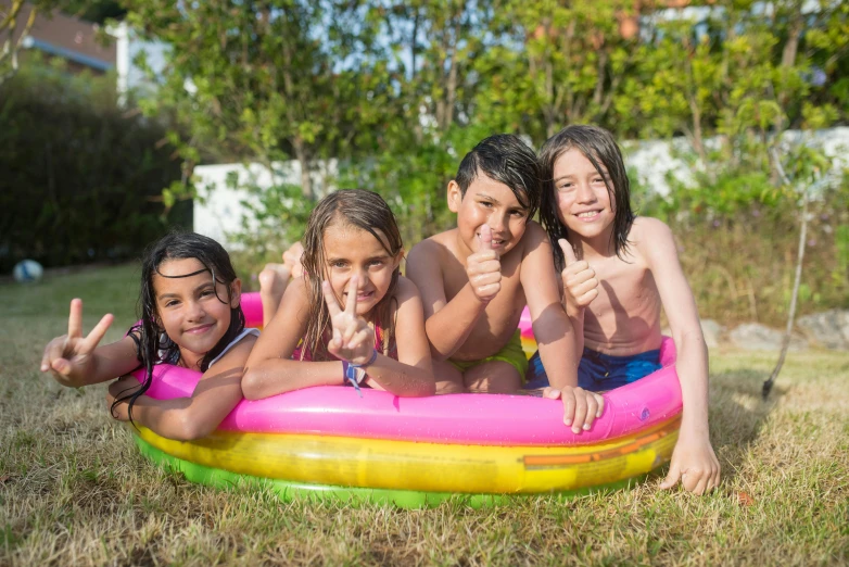 a group of children laying on top of an inflatable pool, by Lilia Alvarado, figuration libre, avatar image, high quality picture, gardening, profile image