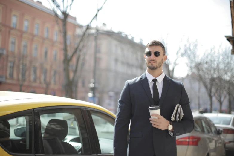 a man in a suit holding a cup of coffee, by Sebastian Vrancx, pexels contest winner, taxi, avatar image, caucasian, full-body