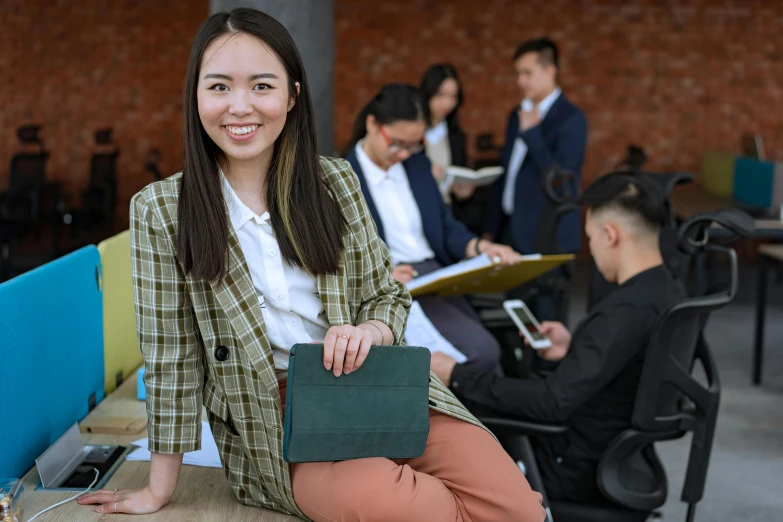 a woman sitting on a bench in front of a group of people, hoang lap, avatar image, academic clothing, holding notebook