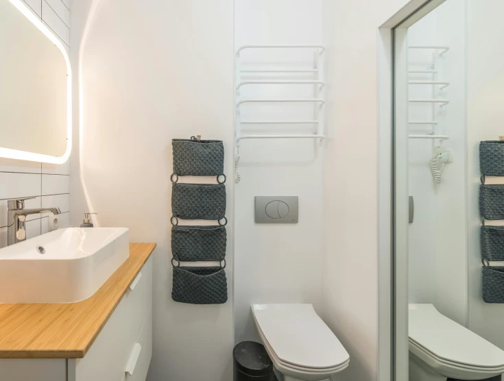 a bath room with a toilet a sink and a mirror, by Konrad Witz, light and space, manly design, perfect bright studio lighting, showers, electrical