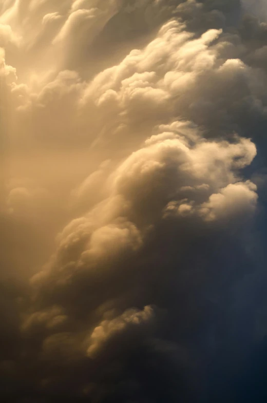 a jetliner flying through a cloudy sky, by Neil Blevins, romanticism, dark mammatus cloud, bathed in golden light, up-close, atmospheric photograph