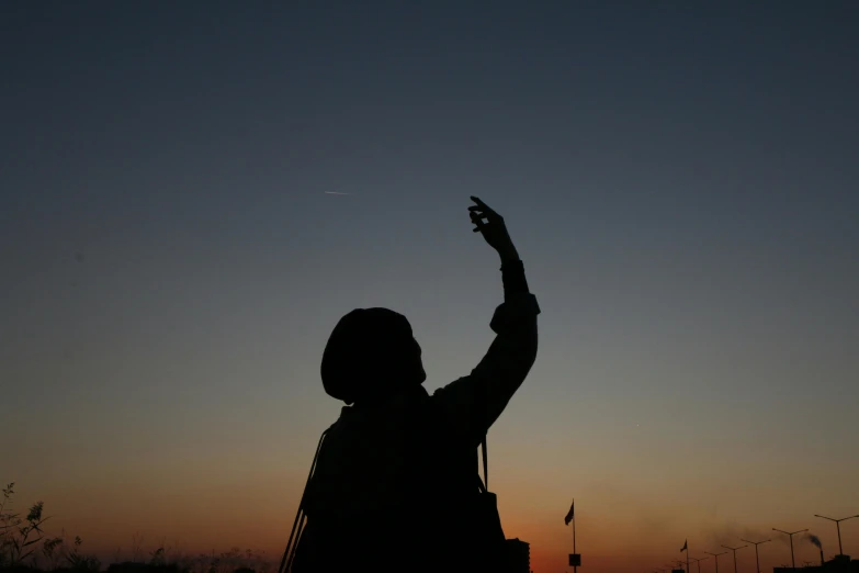 a person that is flying a kite in the sky, by Attila Meszlenyi, saluting, at dawn, pointing, iraq nadar