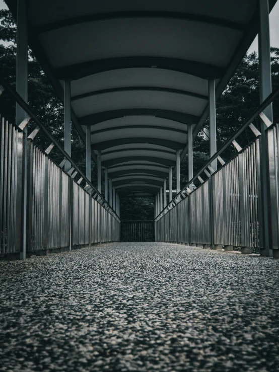 a black and white photo of a walkway, pexels contest winner, asphalt and metal, instagram post, archways, post processed 4k