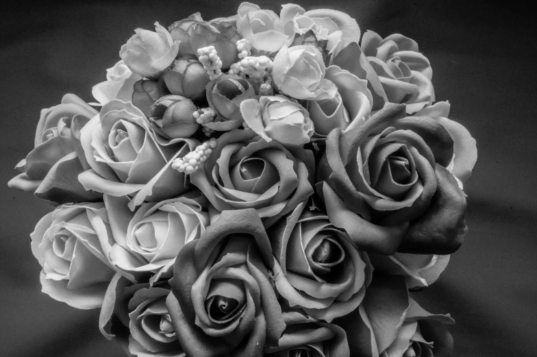 a black and white photo of a bouquet of roses, by Arnie Swekel, flower decorations, black and grey, uploaded, low detail