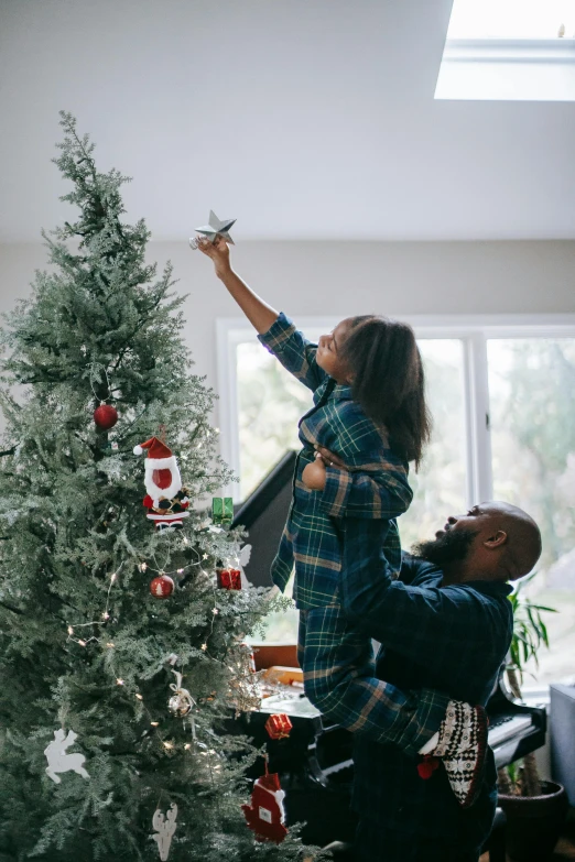 a man and woman decorating a christmas tree, pexels contest winner, happening, better homes and gardens, grey, dwell, highly accurate