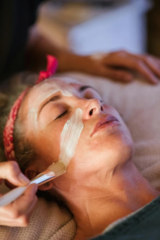 a woman getting a facial treatment at a spa, by Julian Allen, slightly tanned, organic lines, masking, ultra texture