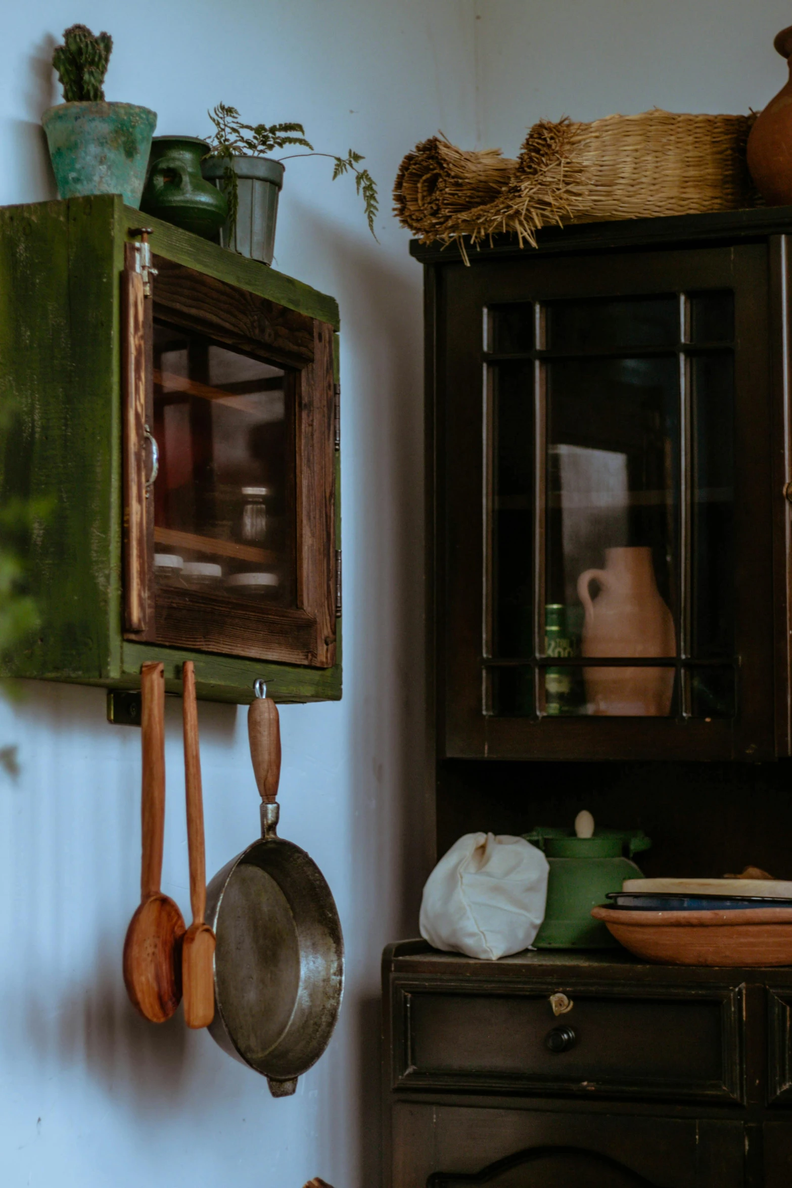 a kitchen with pots and pans hanging on the wall, a picture, unsplash, renaissance, old experimentation cabinet, profile image, green, up close picture