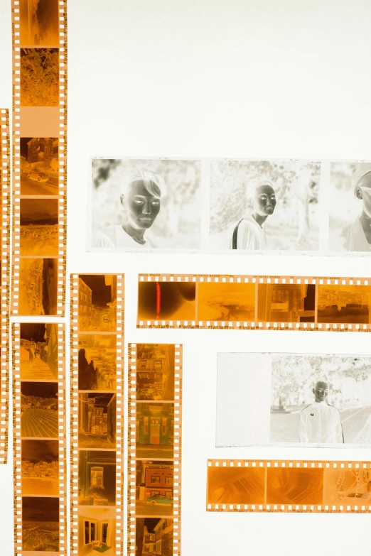 a couple of films sitting next to each other, inspired by Raoul Ubac, unsplash, conceptual art, kodak gold film, zoomed out to show entire image, virgil abloh, orange and white color scheme