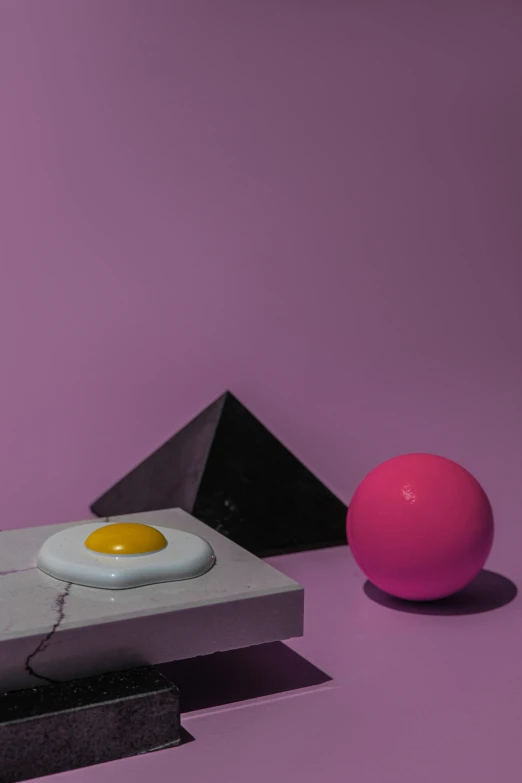 an egg sitting on top of a table next to a pink ball, an abstract sculpture, by Doug Ohlson, retro-wave vibes, singularity sculpted �ー etsy, ignant, laura watson