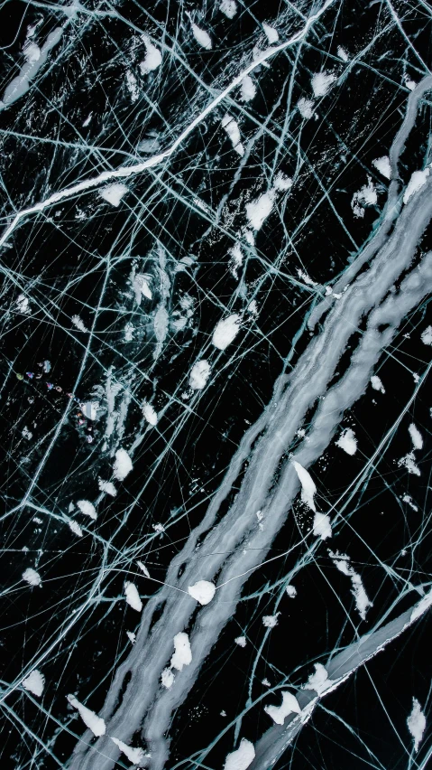 a close up of a black and white marble surface, inspired by Pollock, pexels, black wired cables, glass shattering, splattered goo, glacier