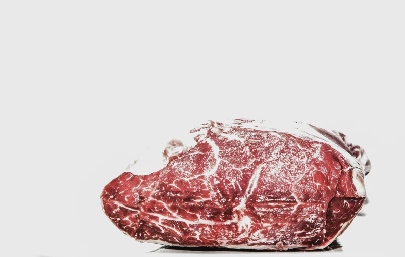 a piece of meat sitting on top of a table, by Gavin Hamilton, unsplash, hyperrealism, on a white background, plastic wrap, beef, illustration:.4