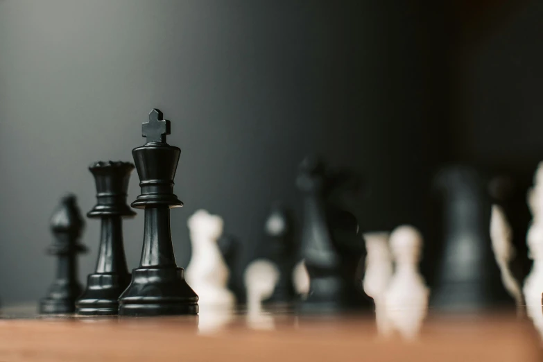 a group of chess pieces sitting on top of a wooden table, unsplash, background image, profile shot, thumbnail, sharp focus »