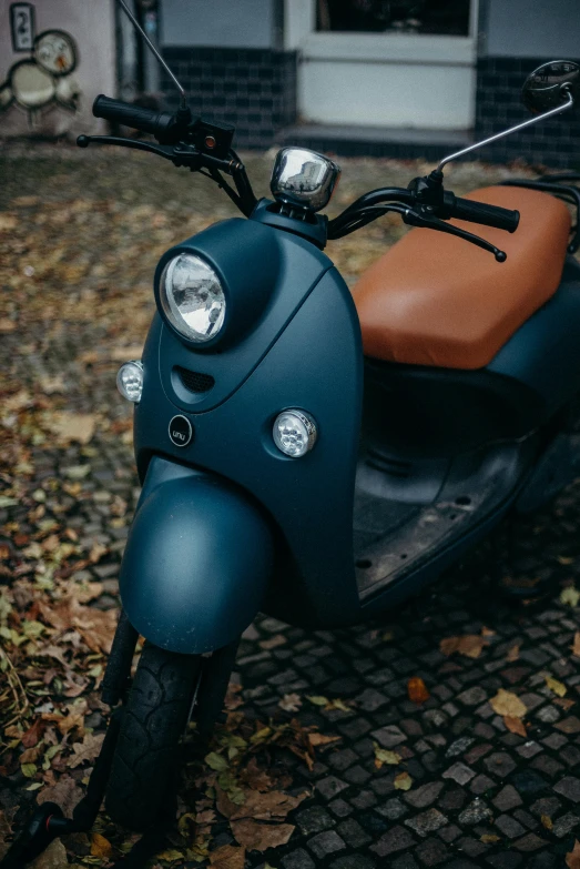 a motor scooter parked in front of a house, by Adam Marczyński, unsplash, dark blue, brown, close up details, avatar image