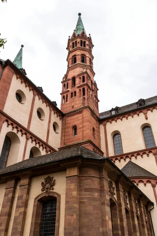 a tall tower with a clock on top of it, inspired by Rainer Maria Latzke, romanesque, copper details, lead - covered spire, view from ground, red building