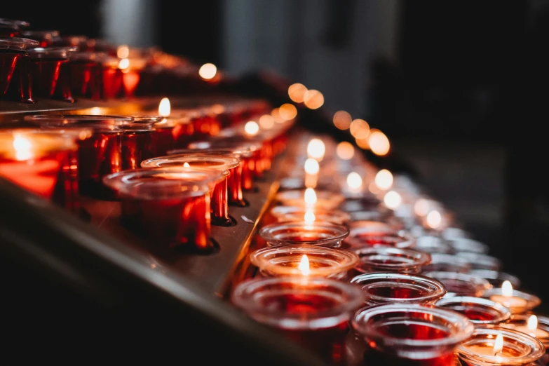 a row of candles sitting on top of a table, by Daniel Lieske, pexels, small red lights, holy themed, instagram post, profile image