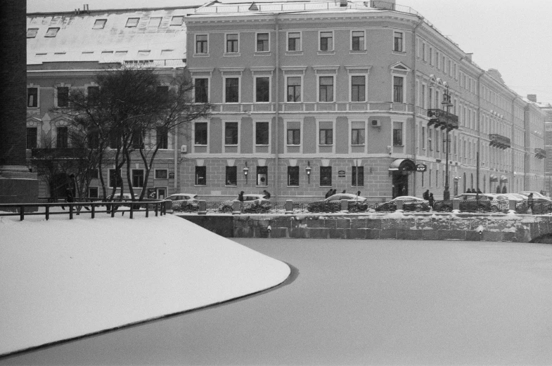 a black and white photo of a city street, a black and white photo, danube school, frozen lake, roman shipunov, white building, gentle snow