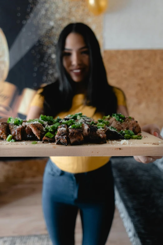 a woman in a yellow shirt holding a tray of food, pexels contest winner, crackling black lightning, steak, recipe, wood print