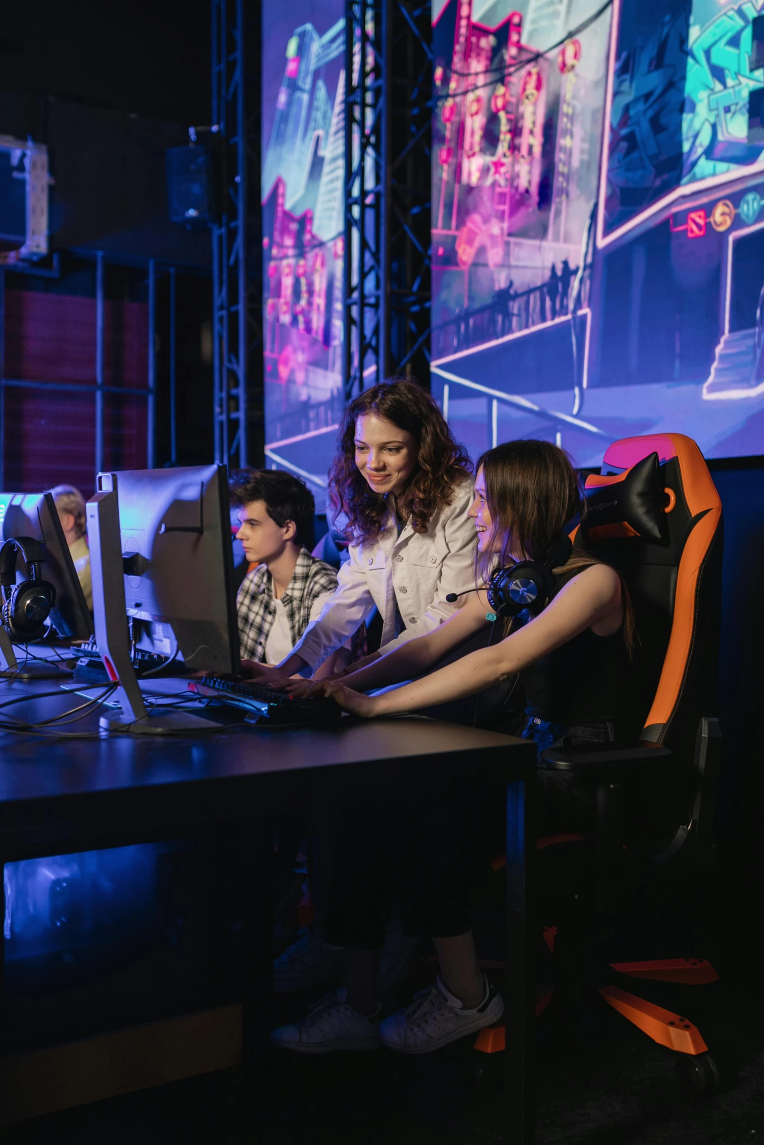 a group of people sitting around a table with computers, a portrait, by Adam Marczyński, shutterstock, e-sport style, arcade game, better known as amouranth, high quality photo