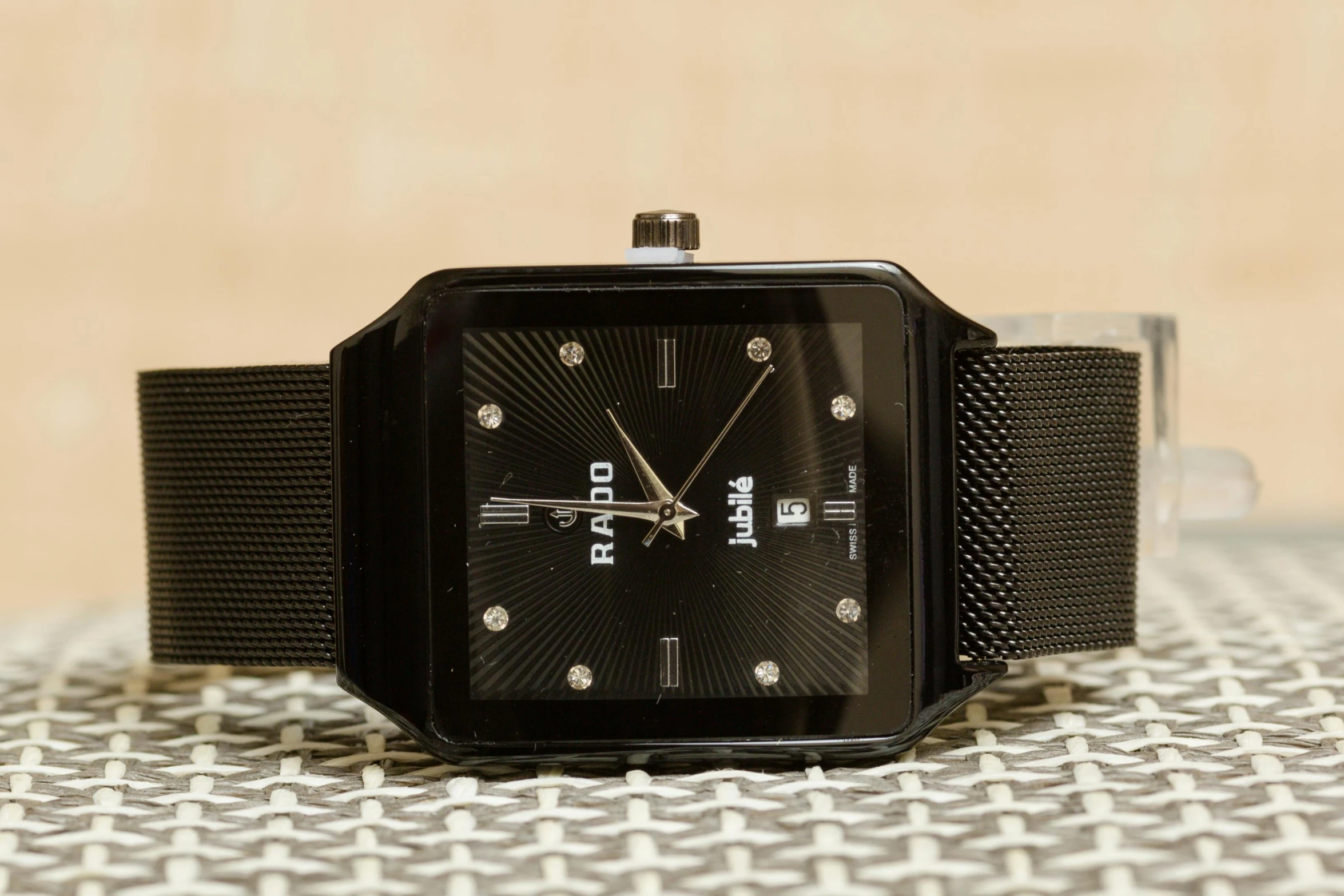 a close up of a watch on a table, a stipple, reddit, square, raal, black matte finish, a radiant