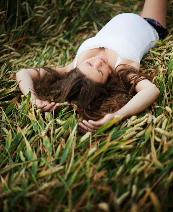 a woman laying in the grass with her eyes closed, unsplash, renaissance, farming, taken in the late 2010s, photo of a model, high grain