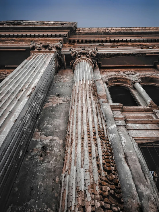 an old building with columns and windows, inspired by Hubert Robert, pexels contest winner, weathered artifacts, brown, brutal archi, gigantic pristine marble columns