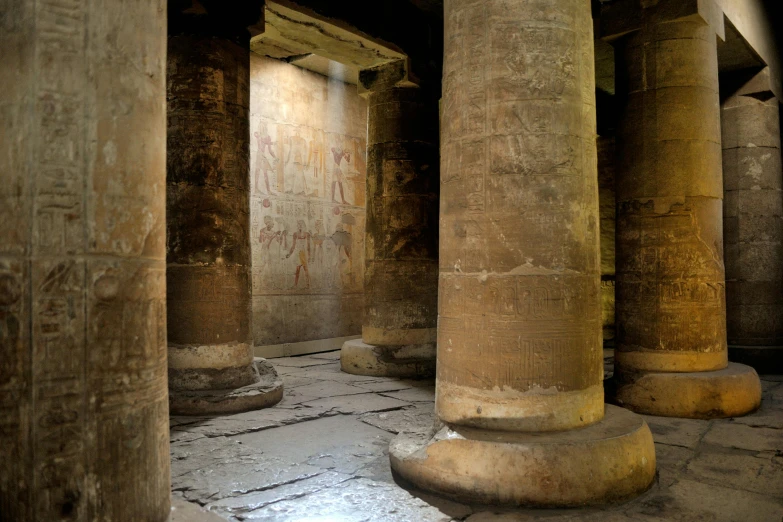 a group of pillars sitting next to each other, egyptian art, by Thomas Barker, pexels contest winner, graffiti, in a monestry natural lighting, lumen global illumination, high resolution photo, an ancient