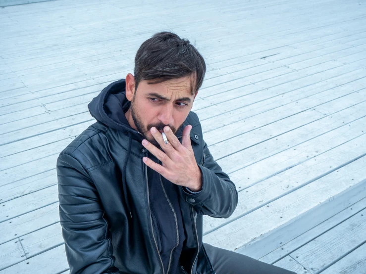 a man sitting on a bench smoking a cigarette, an album cover, pexels contest winner, leather clothing, h3h3, hasan piker, his palms are sweaty