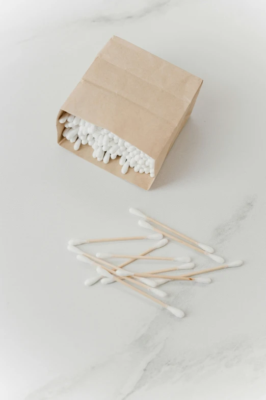 a box of matches sitting on top of a table, lots of white cotton, profile image, surgical supplies, buds