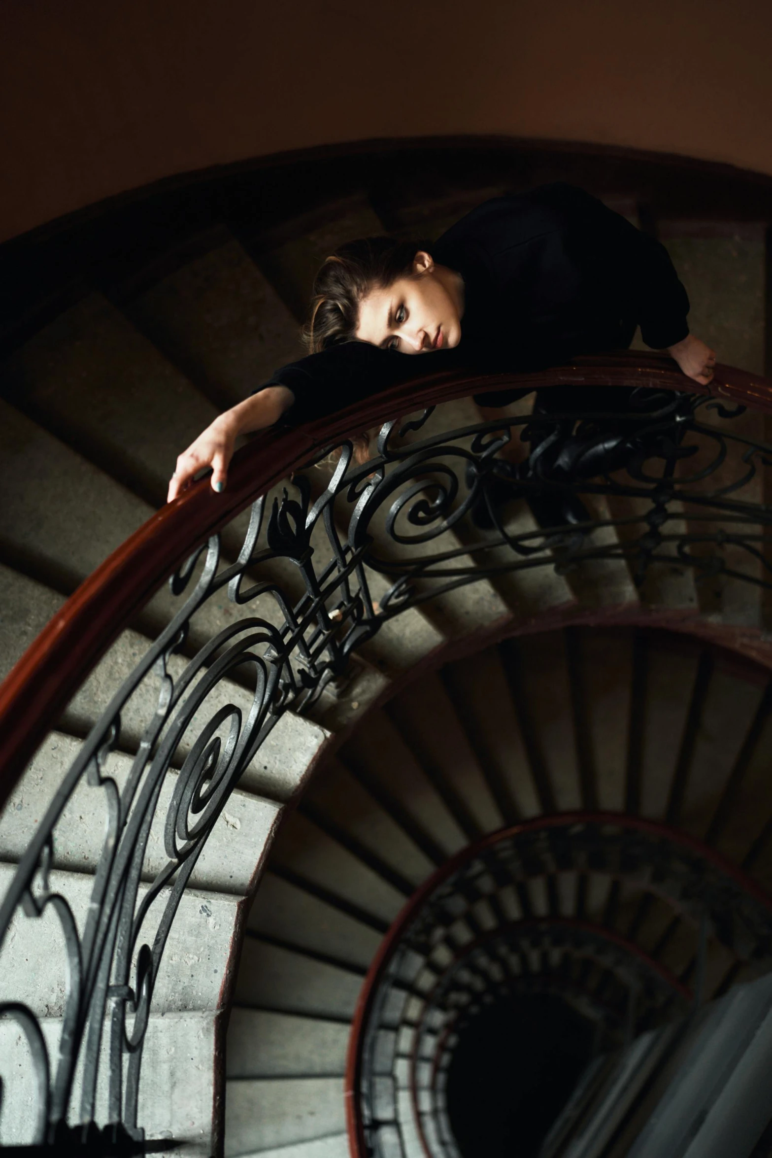 a woman standing at the top of a spiral staircase, a portrait, inspired by Gustave Caillebotte, pexels contest winner, baroque, resting, head down, mid shot portrait, lena oxton