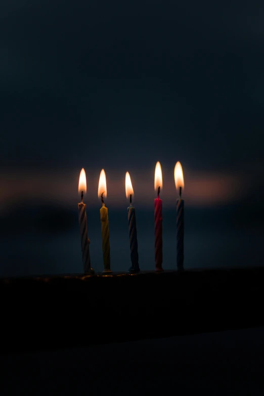 a group of lit candles sitting on top of a window sill, by Niko Henrichon, pexels, happy birthday candles, avatar image, on a gray background, 5 0 0 px