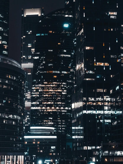 a group of tall buildings in a city at night, a screenshot, unsplash contest winner, hq 4k phone wallpaper, hyperdetailed photo, snapchat photo, low detailed