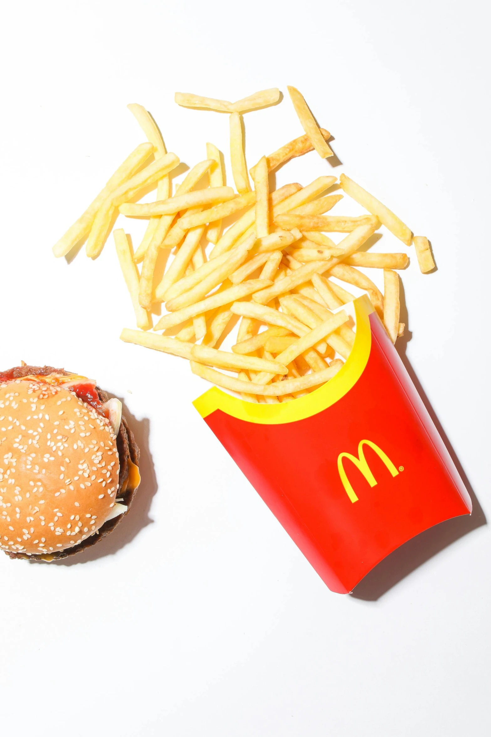 a hamburger and french fries on a white surface, unsplash, photorealism, mc donalds, snapchat photo, promo image, 2 0 0 0's photo