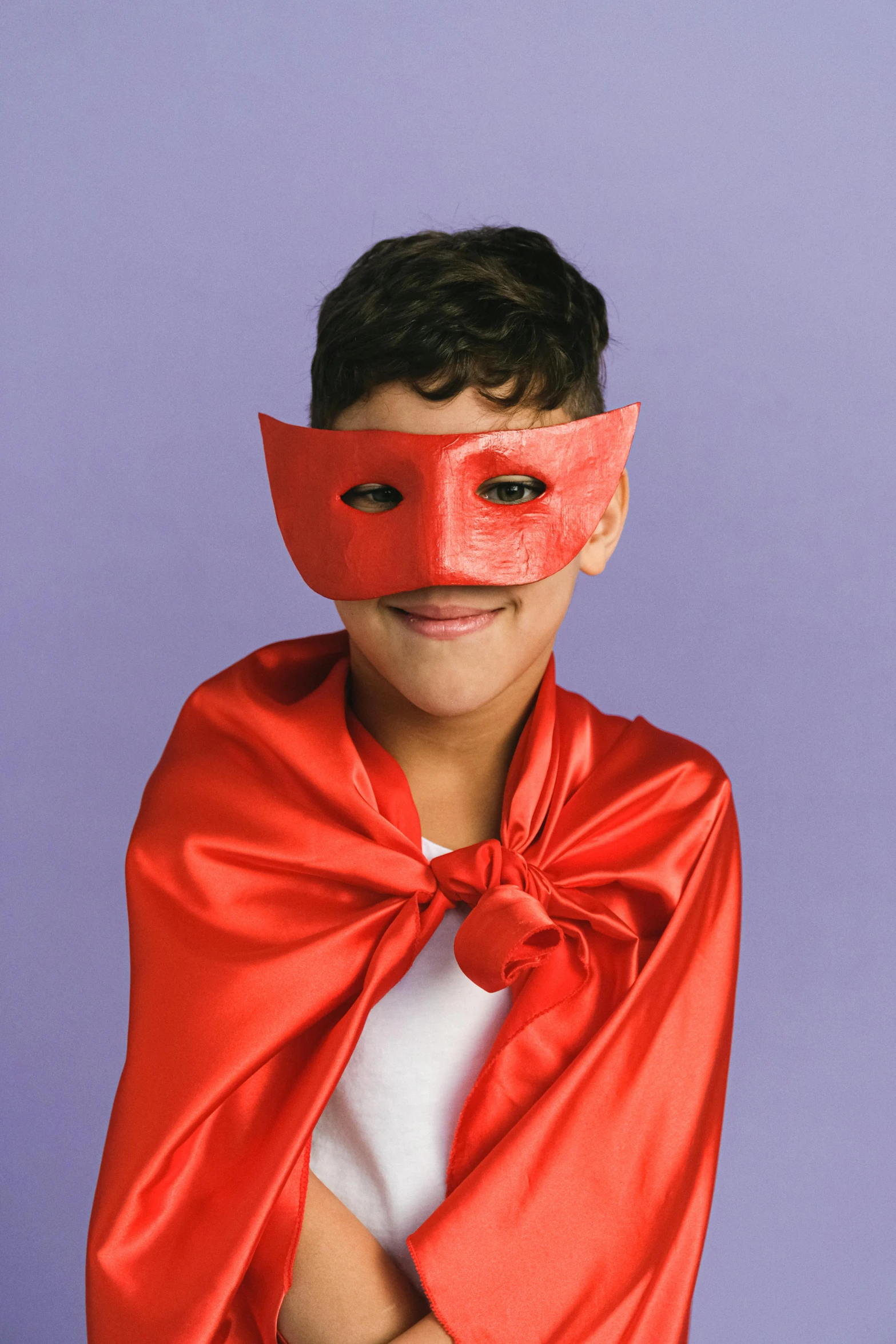 a young boy wearing a red cape and a red mask, inspired by Raphael, trending on pexels, pop art, drag queen, puerto rican super hero, wide nostrils, official product photo