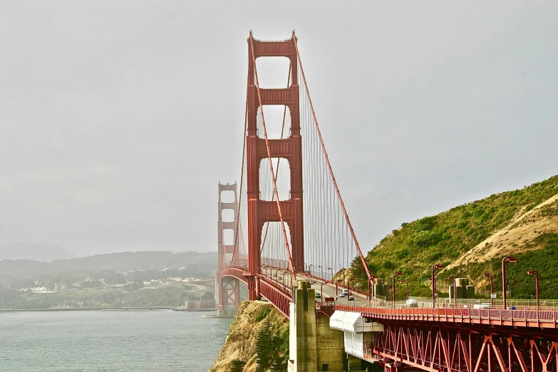 a train crossing a bridge over a body of water, a colorized photo, pexels contest winner, renaissance, golden gate, frank gehry, slight overcast, arch