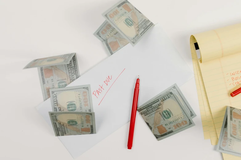 a pile of money sitting on top of a piece of paper, red ballpoint pen, thumbnail, product view, modeled