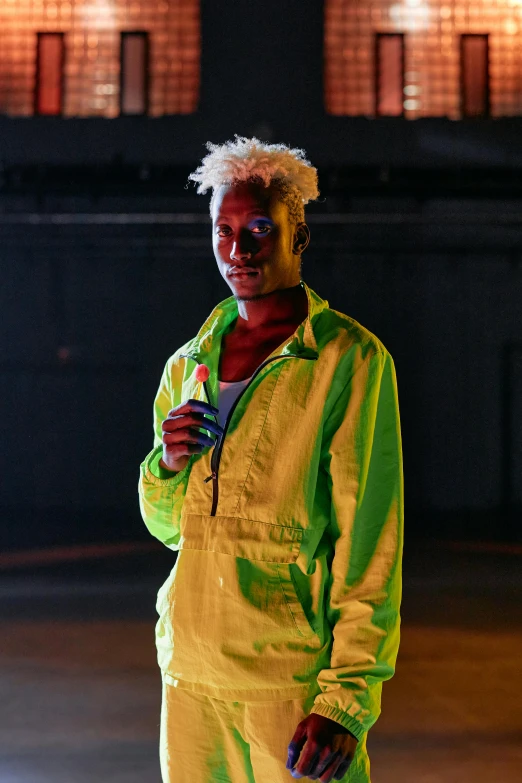 a man in a yellow suit standing on a skateboard, trending on pexels, afrofuturism, glowing green neon eyes, a silver haired mad, posing in dramatic lighting, model wears a puffer jacket