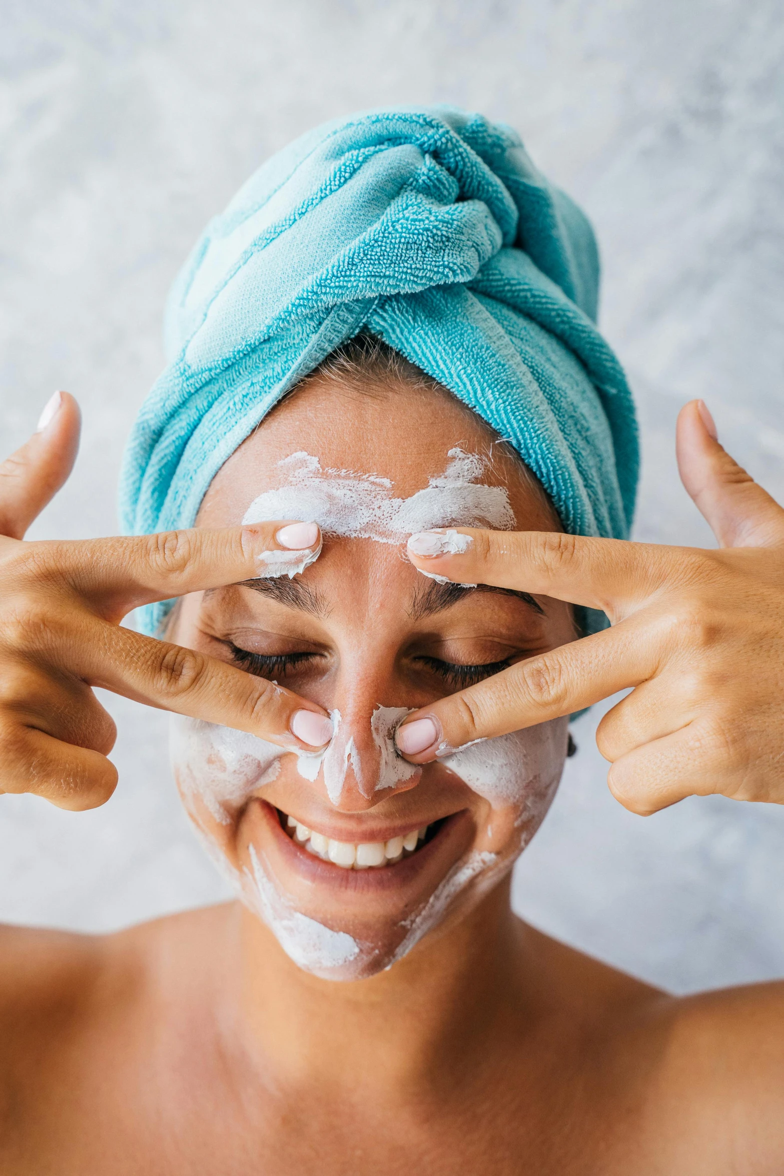 a woman with a towel on her head shaving her face, a portrait, trending on pexels, renaissance, smiling mask, hands shielding face, square, glomy