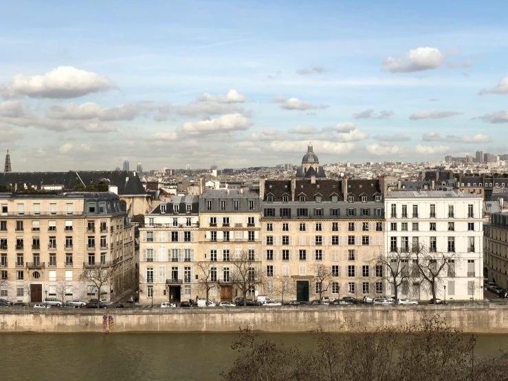 a view of a city from the top of a hill, a photo, paris school, waterfront houses, 2022 photograph, conde nast traveler photo, riverside