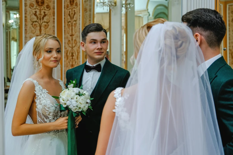 a man standing next to a woman in a wedding dress, by Maksimilijan Vanka, pexels contest winner, green and white, scene from church, smirking, group of people