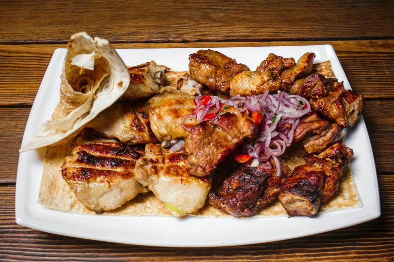 a close up of a plate of food on a table, by Emma Andijewska, kebab, grilled chicken, 3 heads, “the ultimate gigachad