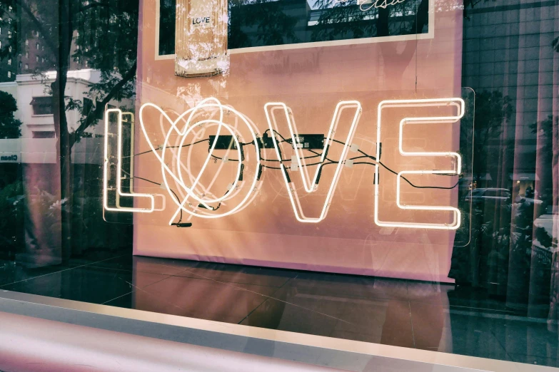 a neon sign that says love in front of a window, a picture, by Joe Bowler, trending on unsplash, instagram story, award winning shopfront design, 💋 💄 👠 👗, love peace and unity