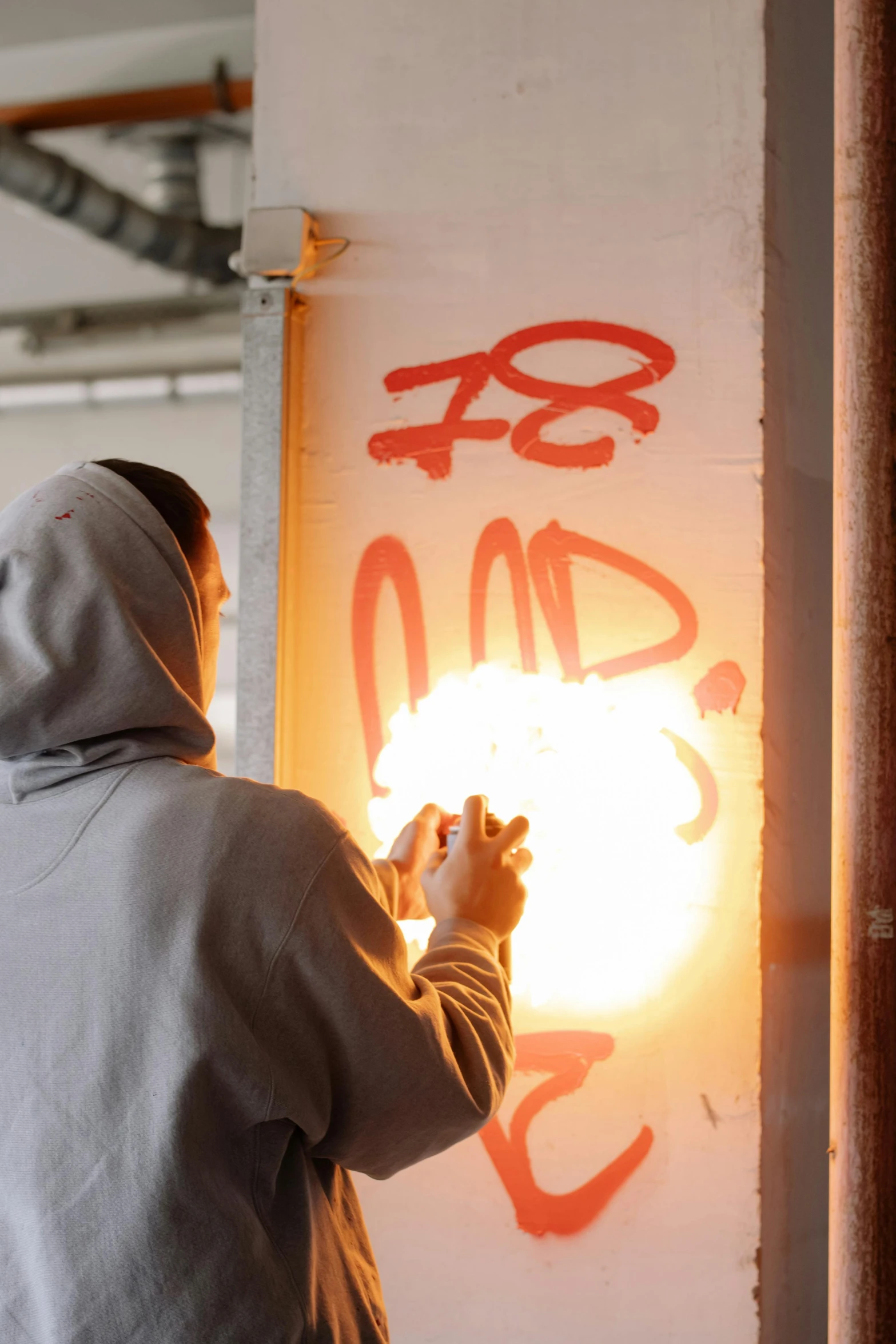 a man standing in front of a wall with graffiti on it, casting fireball, tag, eight eight eight, profile image