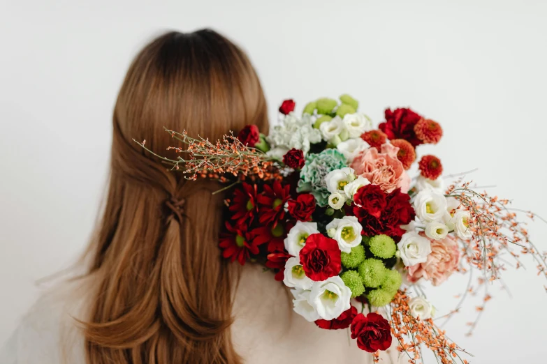 a woman with a bunch of flowers in her hair, a still life, trending on unsplash, red brown and white color scheme, arched back, full product shot, mid - length hair