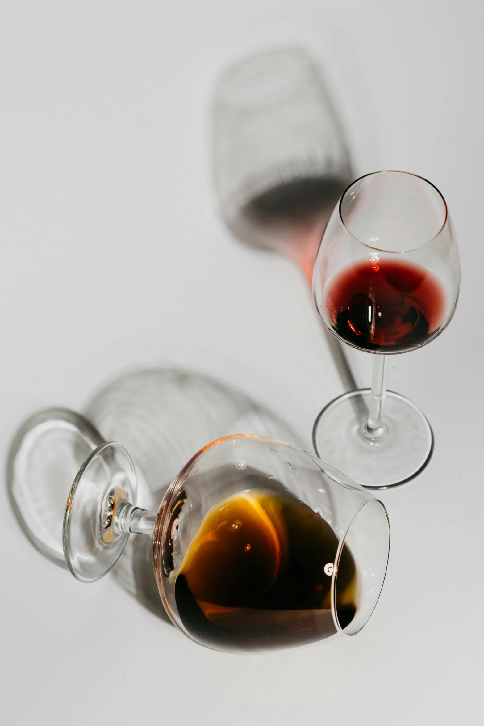 a couple of wine glasses sitting next to each other, black and auburn colour pallet, up-close, julia sarda, multiple stories