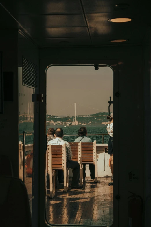 a group of people sitting on top of a boat, looking out the window, sitting on a chair, unsplash photography, lisbon