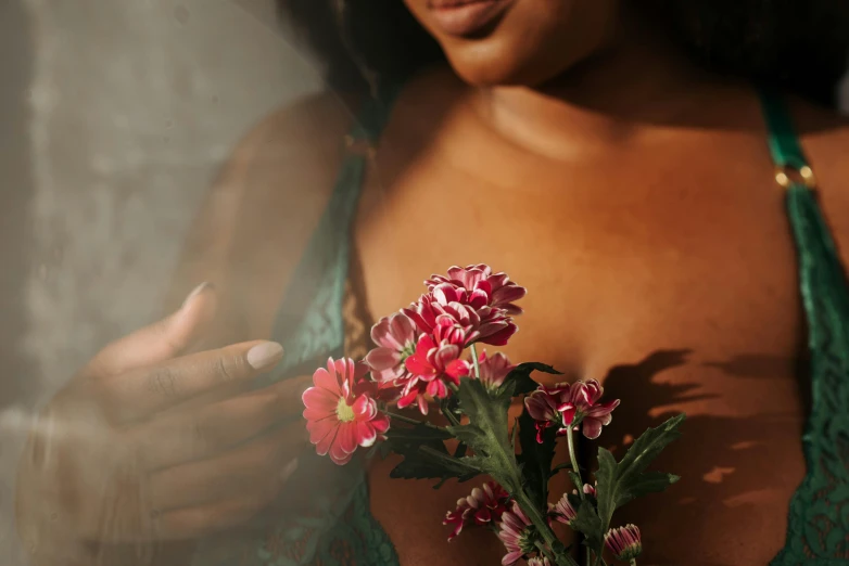 a close up of a person holding a flower, an album cover, inspired by Elsa Bleda, trending on pexels, romanticism, sexy girl with dark complexion, laced lingerie, holding magic flowers, natural morning light